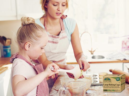 Cute little girl baking in the kitchen at home with her mom